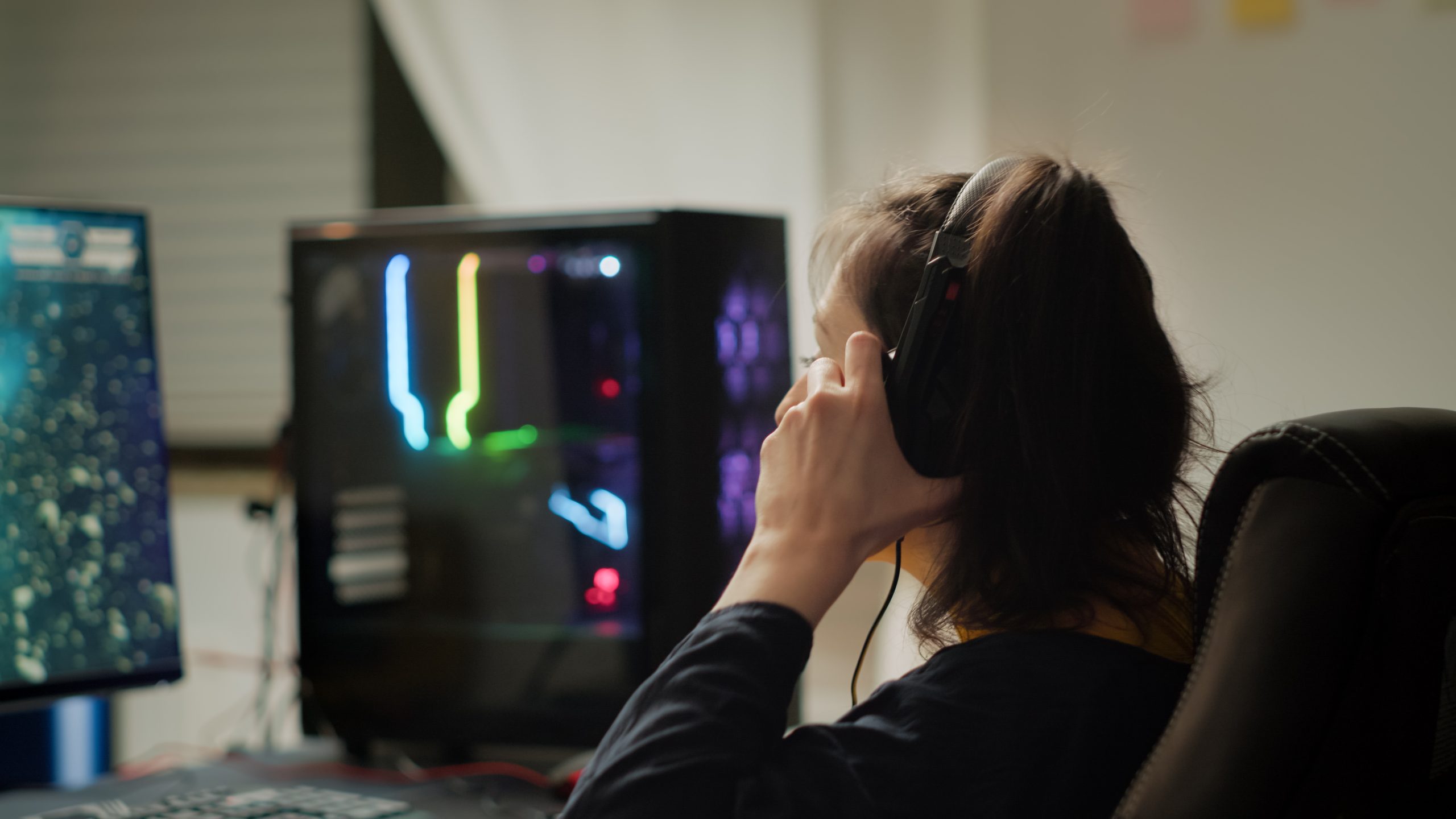 Professional eSport gamer with headset playing in competitive video games